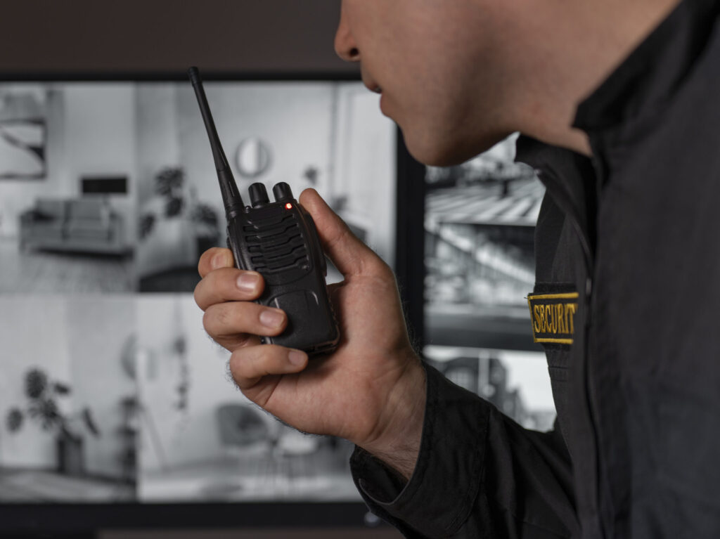 portrait male security guard with radio station camera screens (1)