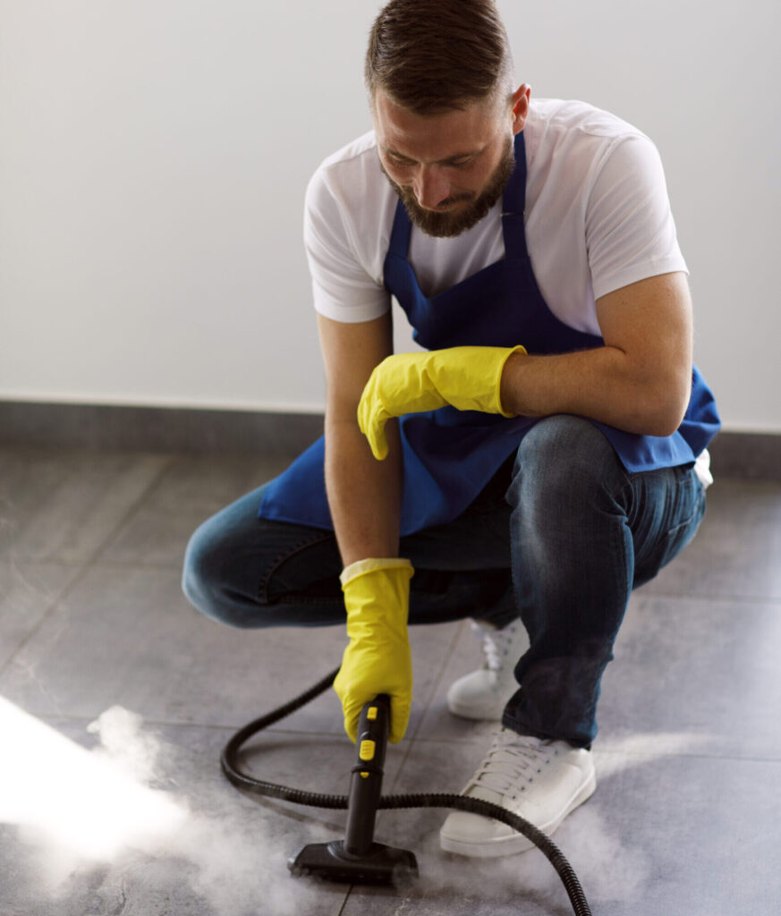 professional cleaning service person using steam cleaner office